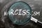 Learn, study and inspect narcissism - pictured as a magnifying glass enlarging word narcissism, symbolizes researching, exploring