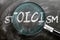 Learn, study and inspect stoicism - pictured as a magnifying glass enlarging word stoicism, symbolizes researching, exploring and