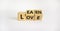 Learn to love symbol. Turned wooden cubes and changed the word `love` to `learn`. Beautiful white background. Learn to love an