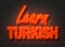 Learn Turkish, neon sign on brick wall