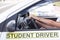 Learner driver holding steering wheel during driving lesson