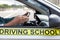 Learner driver student driving car with instructor