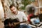 Learning guitar. Close up of attractive male music blogger sitting on the floor and showing how to play guitar with
