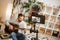 Learning guitar. Male music blogger sitting on the floor at home and recording new guitar lesson with camera on