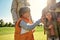 Learning more about animals. Excited little boy watching young dappled deer and smiling while spending great time with