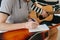 Learning to play the guitar. Music education and extracurricular lessons. Hobbies and enthusiasm for playing guitar and