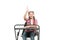 She learnt the lesson. Cute school child with raised hand sitting at school desk. Little schoolgirl reciting lesson at