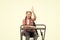 She learnt the lesson. Cute school child with raised hand sitting at school desk. Little schoolgirl reciting lesson at