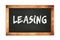 LEASING text written on wooden frame school blackboard