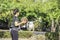 Leather basketball in hand of a woman wearing a watch Background blur tree in Bang Yai park , Nonthaburi , Thailand.May 24, 2019