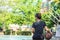 Leather basketball in hand of a woman wearing a watch Background blur tree in Bang Yai park , Nonthaburi , Thailand.May 24, 2019