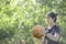 Leather basketball in hand of a woman wearing a watch Background blur tree in Bang Yai park , Nonthaburi , Thailand.May 24, 2019