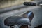 Leather bicycle seat and steering wheel fragment, blurred background