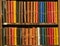 Leather bound books of various colors in an antique bookstore