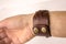 Leather brown homemade bracelet on his hand