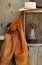 Leather chaps, cowboy hats, lantern on shelf