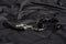 Leather collar on black silk background. Accessories for adult BDSM