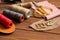 Leather craft instruments on wooden background close up