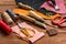 Leather craft instruments on wooden background close up