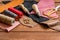 Leather craft instruments on wooden background close up