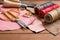 Leather craft instruments on wooden background close up