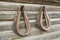 Leather horse collars on log cabin wall