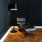 Leather lounge chair in new black interior with wooden parquet f