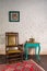 Leather rocking chair, wooden green vintage table and antique golden telephone set over bricks wall