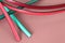 Leather strips laces motif in vivid colors on pink pastel leather background