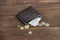 Leather wallet with dollars on a wooden background