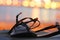 Leather woman sandal in sunset background