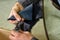 Leather worker processes the product, polishes