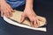 Leather worker workshop. Man holding crafting tool and working, close up. Making things handmade