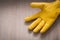 Leather yellow gardening safety glove on wooden