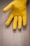 Leather yellow gardening safety glove on wooden