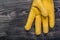 Leather yellow protective glove on vintage wooden board maintena