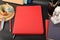 Leather Zipper Portfolio. Concept shot, top view, flap portfolio in red colors and leather pen. Custom background flap portfolio
