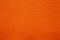 Leatherette texture in magnificent orange colour. Bright orange leather background.