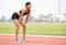 Leave it all on the track. Full length shot of an attractive young female athlete hunched over on the track after a race