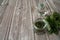 Leaves of nettle dioecious, vodka in a jug and ready-made tincture of nettle in a jar on a wooden background.