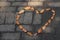 Leaves in the shape of a hart on dark rough paving