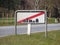 Leaving Town Sign at Road with Grass