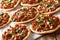 Lebanese Meat Pie Recipe Sfeeha with ground meat, onions, tomato, and pine nuts closeup. horizontal