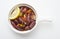 Lebanese starters of Sausage meat marinated, sausages fried in a metal pan isolated on white