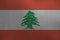 Lebanon flag depicted in paint colors on old brushed metal plate or wall closeup. Textured banner on rough background