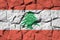 Lebanon flag depicted in paint colors on old stone wall closeup. Textured banner on rock wall background