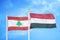 Lebanon and Yemen two flags on flagpoles and blue cloudy sky
