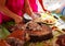 Lechon national philippine dish with waitress hand. Woman sells fried pork in Asian country