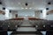 A lecture hall with empty seats and a large screen