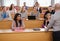 Lecturer and multinational group of students in an auditorium